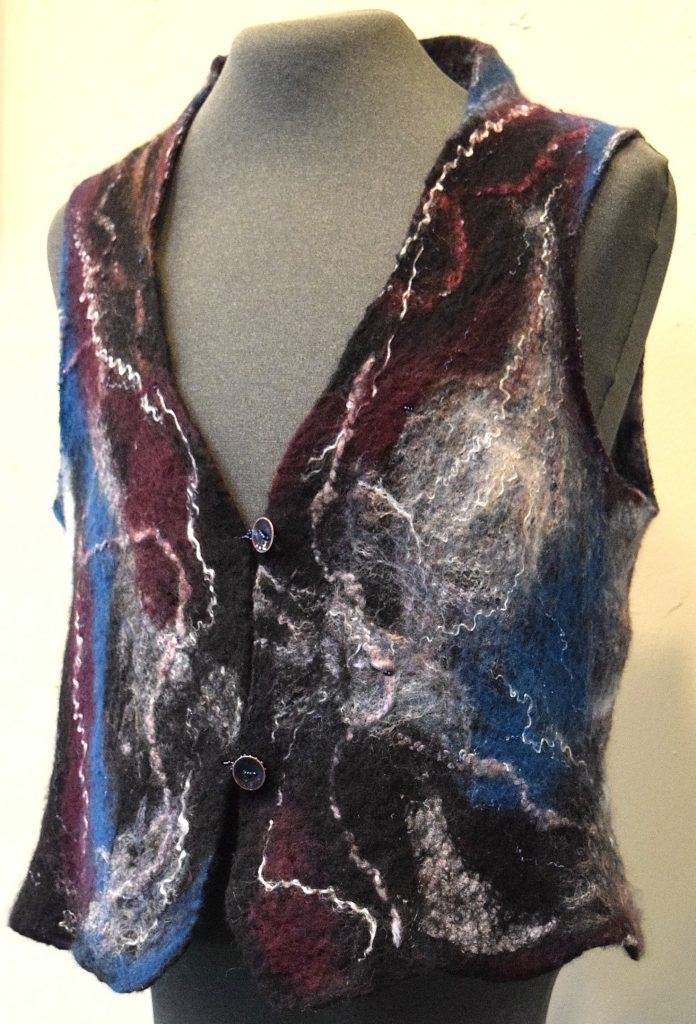 Maroon, blue, black & white Merino Wool vest with a black Cotton Gauze base. Tencel and beadwork add a little sparkle and bead loops hook on the hand crafted Copper & Enamel buttons. Size Medium (10/12) ~ $125