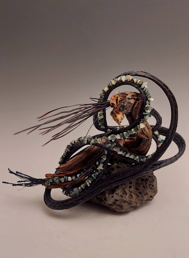 “Coiled Sagebrush Sculpture- Dragon”
This sagebrush branch conjured up a dragon breathing fire. Waxed with encaustic medium and encircled with pine needle coils and agate chip beads.  Sold
