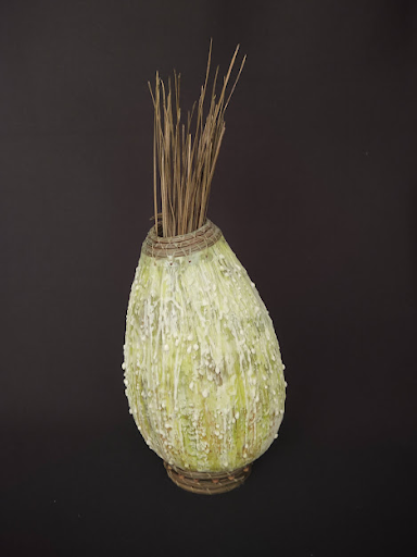 “Dewy Meadow” has textured layers of colored encaustic medium and dyed pine-needle coiling on the rim and base, and has a ‘bouquet’ of pine needles. 12"h