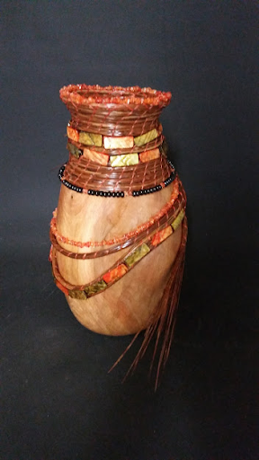 Uzuri is a name meaning Beauty in Swahili. Doug turned the beautiful vase and Lyn added the pine needle coiling and shells/beads. 12”h x 8”w