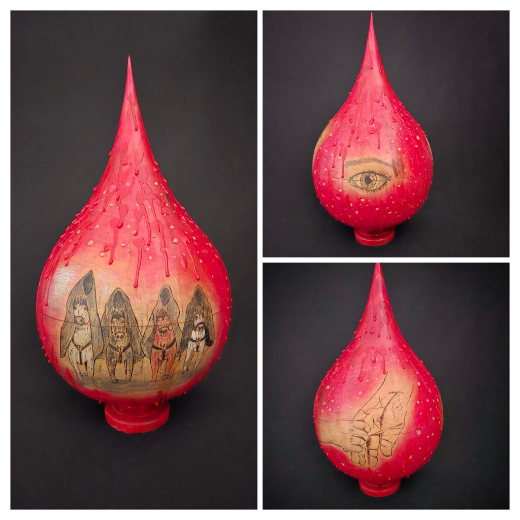 "Blood Red Moon" is inspired by Rod Nelson's poem of the same name and was accepted into the "Inspired: The Art of Poetry" show at Larson Gallery, winning the Director's Choice Award. Doug wood turned the moon tear-drop and added the art work. Lyn added encaustic medium with textured red blood drops.