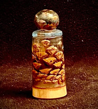 “PinCone on a PineCone #6”
A wee one, this ring box—only 1 1/2”X4”. She wAnted to keep just a little nostalgia note in it and a little diamond memory from days gone by. At least, that’s what I imagined when I decided to make it.
Fashioned from dunking a pine cone in the base and another cone in the lid. My 2-CarbonOxygen Rings potion is getting uses again and again these days. Turned, hollowed, sanded, polished, lacquered.