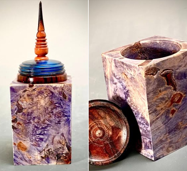 “Lavender Box, Blue Lid”
Boxes are a place to put a little something. A precious ring, a love note keepsake, a little pic of someone passed, a lock of hair, a poem you did in hi-school…And the box has to be special, not just any box. It has to have a finial and the finial must be from far away. Hmmm. Make it ebony from Indonesia. And the body has to be a fantasia to see, what with color and crazy grain, a few tiny repaired knots. The lid could be resin, but the color must complement the body and it has to have anxembedded pinecone to commemorate the wild woods source.
And there you have it, Box#10122025
